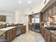Well-equipped kitchen with custom wood cabinetry, stainless steel appliances, and a breakfast bar at 7129 E Caron Dr, Paradise Valley, AZ 85253