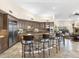 Spacious kitchen featuring a stone island with seating and adjacent living area with fireplace at 7129 E Caron Dr, Paradise Valley, AZ 85253