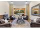 Bright living room featuring a decorative rug, comfortable seating, and a grand picture window view of the pool at 7129 E Caron Dr, Paradise Valley, AZ 85253