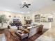 Comfortable living room featuring a fireplace, bar area, hardwood floors, and a ceiling fan at 7129 E Caron Dr, Paradise Valley, AZ 85253