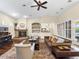 Inviting living room with hardwood floors, stone fireplace, ceiling fan and access to the outdoor patio at 7129 E Caron Dr, Paradise Valley, AZ 85253