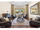 Elegant living room featuring an area rug, comfortable seating, and a grand picture window overlooking the pool at 7129 E Caron Dr, Paradise Valley, AZ 85253