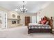 Comfortable main bedroom with a fireplace and soft carpet, creating a cozy ambiance at 7129 E Caron Dr, Paradise Valley, AZ 85253