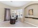 The office features a custom desk, built-in shelving, and a window with plantation shutters at 7129 E Caron Dr, Paradise Valley, AZ 85253