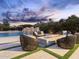 Inviting pool area with a modern fire pit, waterfall feature, and comfortable lounge seating at 7129 E Caron Dr, Paradise Valley, AZ 85253