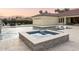 Resort-style pool and spa with travertine pavers and waterfall feature for luxurious outdoor living at 7129 E Caron Dr, Paradise Valley, AZ 85253