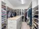 Spacious walk-in closet boasts custom shelving, drawers, and ample hanging space for clothes and accessories at 7129 E Caron Dr, Paradise Valley, AZ 85253