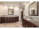 Elegant bathroom features double sinks, custom mosaic backsplash, marble countertops, and tile floors at 7475 E Gainey Ranch Rd # 4, Scottsdale, AZ 85258