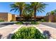 Beautiful building entrance with palm trees, manicured greenery, and paved walkway at 7475 E Gainey Ranch Rd # 4, Scottsdale, AZ 85258