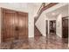 Grand foyer featuring double doors, elegant staircase, and hardwood floors, creating a welcoming first impression at 7475 E Gainey Ranch Rd # 4, Scottsdale, AZ 85258