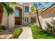 Inviting home exterior with manicured garden path leading to a grand entrance, showcasing classic architectural details at 7475 E Gainey Ranch Rd # 4, Scottsdale, AZ 85258