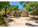 Spacious three-car garage situated on a large driveway, framed by mature trees for added privacy at 7475 E Gainey Ranch Rd # 4, Scottsdale, AZ 85258