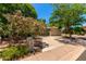 Three-car garage surrounded by lush greenery, enhancing the property's curb appeal in a tranquil setting at 7475 E Gainey Ranch Rd # 4, Scottsdale, AZ 85258