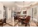 Eat-in kitchen features an island, stainless steel appliances, wood cabinets, light stone countertops, and a cozy breakfast table at 7475 E Gainey Ranch Rd # 4, Scottsdale, AZ 85258