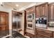 The kitchen features stainless steel appliances, a beverage fridge, and dark wood cabinets providing lots of storage space at 7475 E Gainey Ranch Rd # 4, Scottsdale, AZ 85258