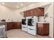 Spacious laundry room featuring tile floors, neutral paint, and updated appliances at 7475 E Gainey Ranch Rd # 4, Scottsdale, AZ 85258