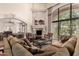Cozy living room with a grand fireplace, plush seating, and large windows offering scenic views, ideal for relaxation at 7475 E Gainey Ranch Rd # 4, Scottsdale, AZ 85258