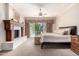Bright main bedroom boasts a fireplace, access to a balcony, and a ceiling fan at 7475 E Gainey Ranch Rd # 4, Scottsdale, AZ 85258