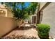 Secluded patio area with mature tree, gravel, and pavers perfect for outdoor relaxation at 7475 E Gainey Ranch Rd # 4, Scottsdale, AZ 85258