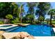 Sparkling pool with rock features, jacuzzi and lush landscaping creates a backyard oasis at 7475 E Gainey Ranch Rd # 4, Scottsdale, AZ 85258