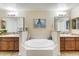 Luxurious bathroom with dual vanities, a soaking tub, and elegant fixtures at 7601 E Indian Bend Rd # 1049, Scottsdale, AZ 85250