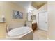 Soaking tub is the highlight of the bathroom, featuring a neutral color scheme and a separate vanity area at 7601 E Indian Bend Rd # 1049, Scottsdale, AZ 85250