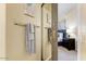 A view into the bedroom with a sliding barn door and towel racks nearby at 7601 E Indian Bend Rd # 1049, Scottsdale, AZ 85250