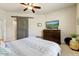 Bedroom features a ceiling fan, barn door, a TV on a dresser, and carpeted floors at 7601 E Indian Bend Rd # 1049, Scottsdale, AZ 85250