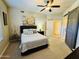 Bedroom with ceiling fan, sliding barn door, neutral walls, and bed with decorative pillows at 7601 E Indian Bend Rd # 1049, Scottsdale, AZ 85250