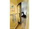 Hallway peek into the bedroom featuring a sliding door, accent wall and dark furniture at 7601 E Indian Bend Rd # 1049, Scottsdale, AZ 85250