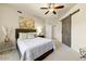 Comfortable bedroom featuring a ceiling fan, stylish decor, and a convenient sliding barn door at 7601 E Indian Bend Rd # 1049, Scottsdale, AZ 85250