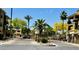 Gated community entrance with palm trees and landscaped surroundings, offering privacy and a secure residential environment at 7601 E Indian Bend Rd # 1049, Scottsdale, AZ 85250