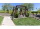 Community outdoor grill area featuring a built-in BBQ and landscaping at 7601 E Indian Bend Rd # 1049, Scottsdale, AZ 85250