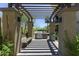 Outdoor grill area with covered pergola, built-in grill, and seating at 7601 E Indian Bend Rd # 1049, Scottsdale, AZ 85250