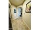 Elegant hallway featuring tiled floors, arched doorways, and stylish decor with neutral-colored walls at 7601 E Indian Bend Rd # 1049, Scottsdale, AZ 85250