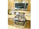 Close-up of a modern stainless steel gas range and oven, microwave, and granite countertops at 7601 E Indian Bend Rd # 1049, Scottsdale, AZ 85250