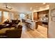 Open-concept living area with tile floors, modern lighting, and updated kitchen at 7601 E Indian Bend Rd # 1049, Scottsdale, AZ 85250