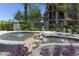 Community entrance with a decorative water fountain and lush plants at 7601 E Indian Bend Rd # 1049, Scottsdale, AZ 85250