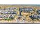 Expansive aerial view of a desert neighborhood featuring modern homes with desert landscaping and a gated entrance at 8138 E Jacaranda St, Mesa, AZ 85207