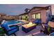 Inviting backyard with a pool, fire pit, and comfortable seating area for outdoor relaxation at 8138 E Jacaranda St, Mesa, AZ 85207