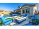 Beautiful backyard with a pool, seating area, fire pit and manicured landscaping at 8138 E Jacaranda St, Mesa, AZ 85207