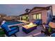 Relaxing backyard with a sparkling pool, fire pit, and comfortable seating; an entertainer's dream at 8138 E Jacaranda St, Mesa, AZ 85207