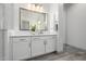 Well-lit bathroom with a large mirror, stylish vanity, and a modern design at 8138 E Jacaranda St, Mesa, AZ 85207