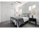 Bedroom with a metal-frame bed, ceiling fan, plantation shutters, and a sliding closet door at 8138 E Jacaranda St, Mesa, AZ 85207