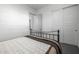 Bedroom featuring a metal-frame bed with white walls and sliding closet doors at 8138 E Jacaranda St, Mesa, AZ 85207