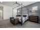 Beautiful bedroom featuring a canopy bed, accent wall, and stylish furnishings at 8138 E Jacaranda St, Mesa, AZ 85207