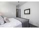 Bedroom featuring a metal-frame bed, neutral decor and an ensuite bathroom entrance at 8138 E Jacaranda St, Mesa, AZ 85207