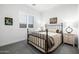 Cozy bedroom with iron bed, natural light and neutral color scheme at 8138 E Jacaranda St, Mesa, AZ 85207