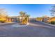 Gated community entrance with mature trees and landscaping at 8138 E Jacaranda St, Mesa, AZ 85207