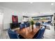 Open dining room with a view of the kitchen and living area, featuring an elegant dining set at 8138 E Jacaranda St, Mesa, AZ 85207